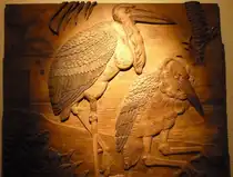 Die in meinen Bildern #13809, #13810 und #13811 von einigen Besuchern zur Zeit noch empfundene k�hle Sachlichkeit des neuen Vogelhauses im Zoologischen Garten Berlin findet ein Gegenst�ck in der alten Fasanerie gegen�ber dem Neubau. Dort finden sich an den W�nden wundersch�ne gro�fl�chige alte Holzschnitzereien mit Vogelmotiven. Hier Marabus. Zoologischer Garten Berlin, Alte Fasanerie, im Mai 2013    